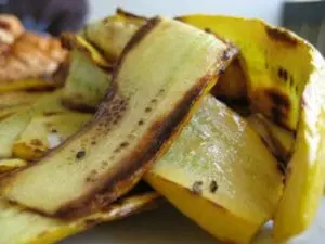 Peeled banana with brown spots and exposed flesh