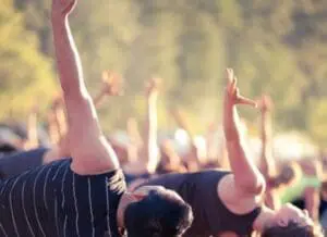 Crowd of people with raised hands at an outdoor event