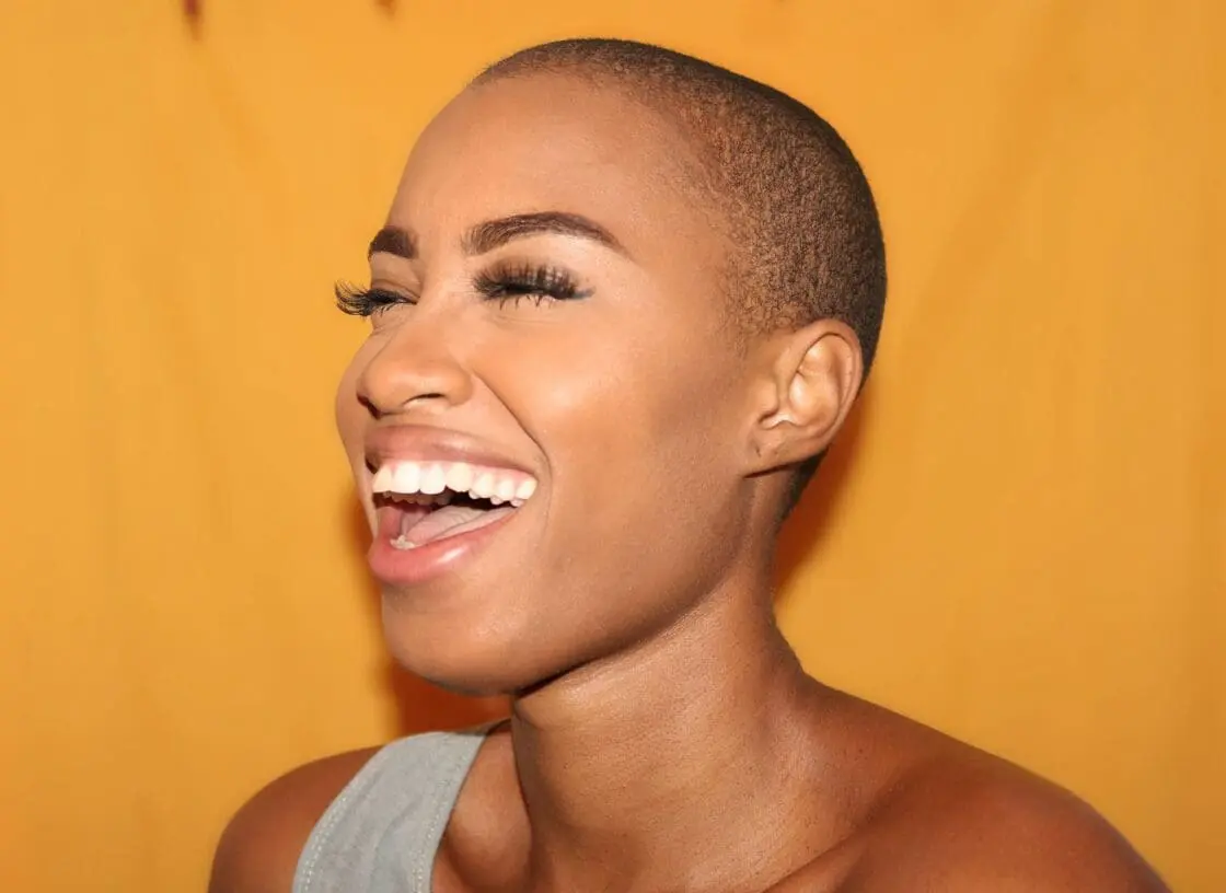 woman with smooth skin, on orange background, thanks to collagen powders with combat wrinkled and sagging skin via Organic Authority