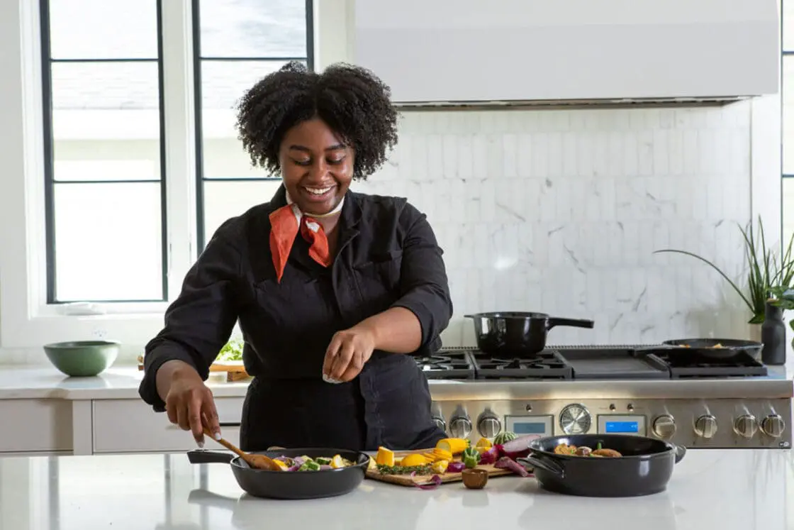 Chef using Xtrema pure ceramic cookware safe cooking in a healthy kitchen. Xtrema cookware is one of the safest cookware brands on the market. Healthy, clean, non-toxic cookware. It's one of the safest materials with just pure ceramic.