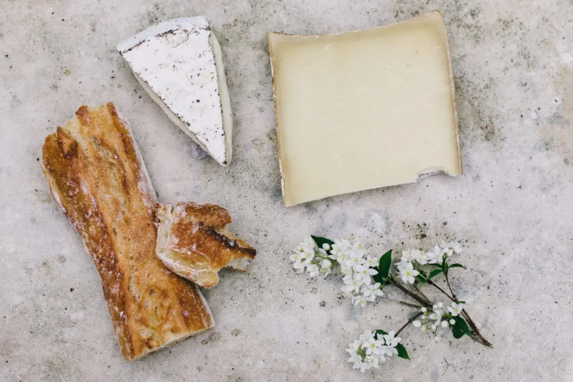 cheese and French bread on cutting board