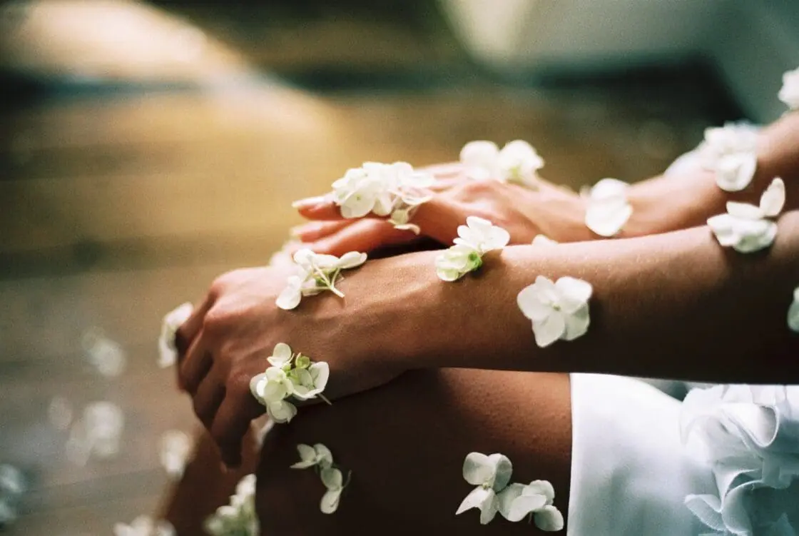 Image of arms with flowers symbolizing the question of vegan source of collagen. There is vegan collagen support!