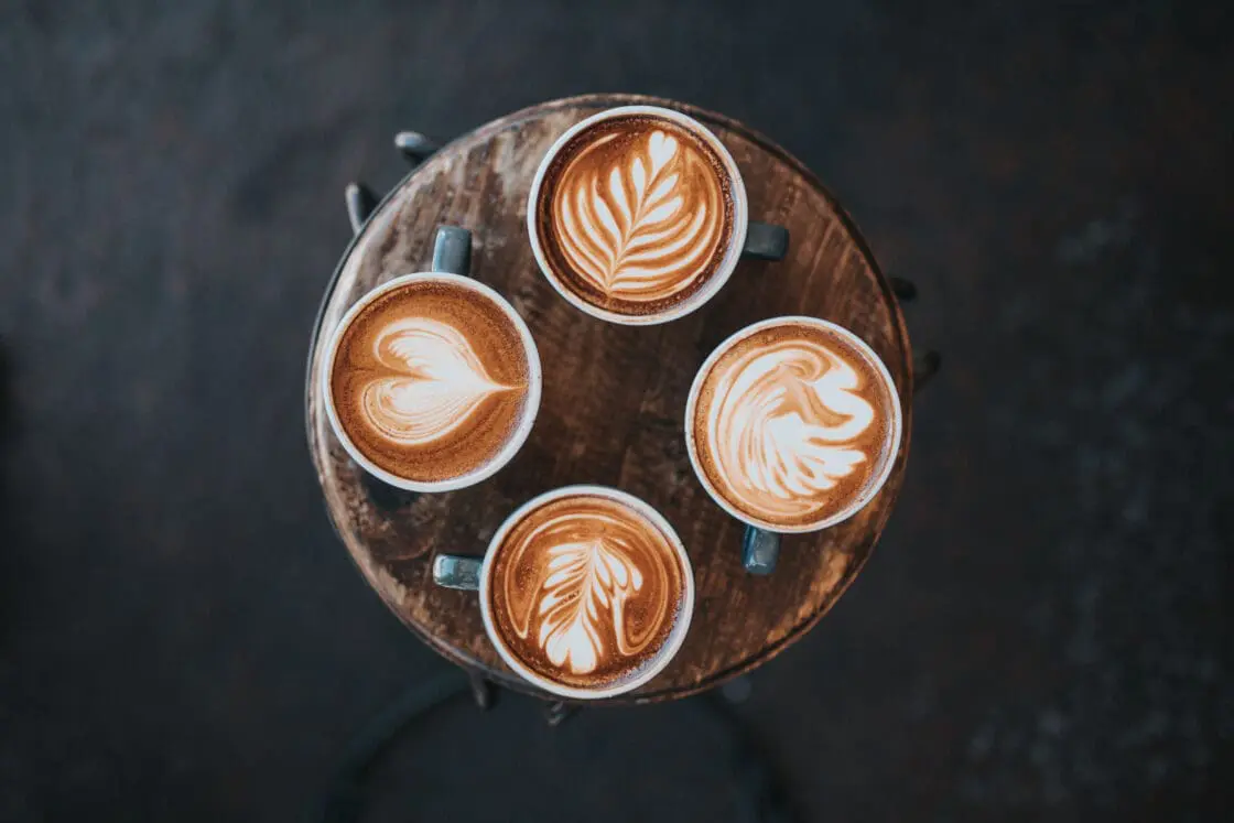 Image of 4 cups of coffee on table. The beauty benefits of collagen in your coffee are real!