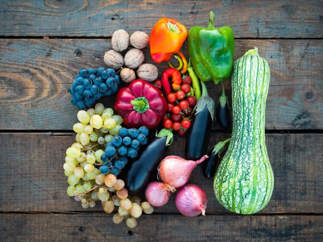 Image of vegan sources of collagen supporting vegetables and fruits, peppers grapes onions zucchini eggplant walnuts