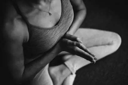 Feed your gut essential probiotics and prebiotics to support your immune system. Person sitting in cross legged yoga pose.