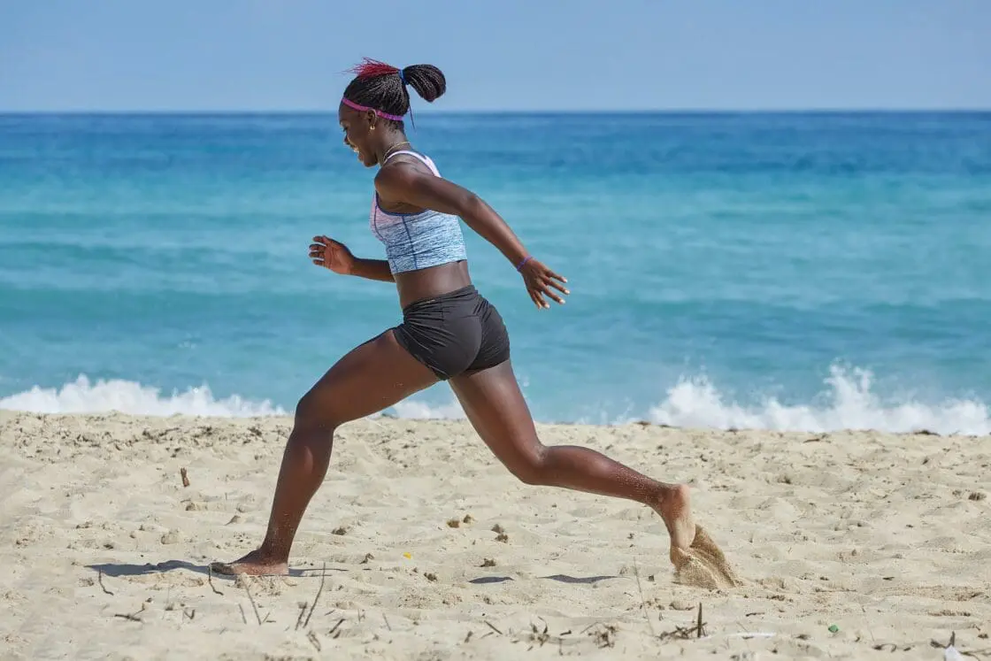 woman running on beach to find the best vegan collagen powder