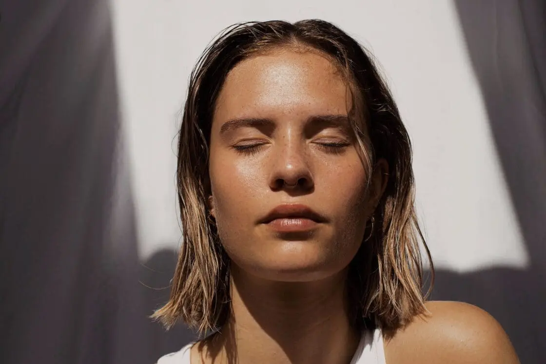 Image of woman in the sunshine with smooth skin supported vitamin c  and collagen supplements