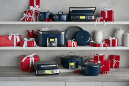Image of GreenPan products, all in Oxford blue, displayed on a counter and two white shelves above and styled with gift boxes wrapped in red paper and white ribbons showing the best gift options for the holiday season.