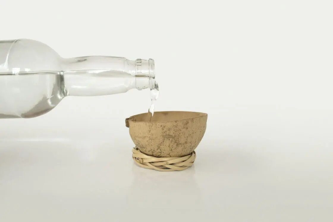 Image of a bottle pouring mezcal to represent what is mezcal. Here's Why Wellness Warriors are Sipping on Mescal
