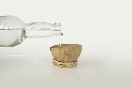 Image of a bottle pouring mezcal to represent what is mezcal. Here's Why Wellness Warriors are Sipping on Mescal