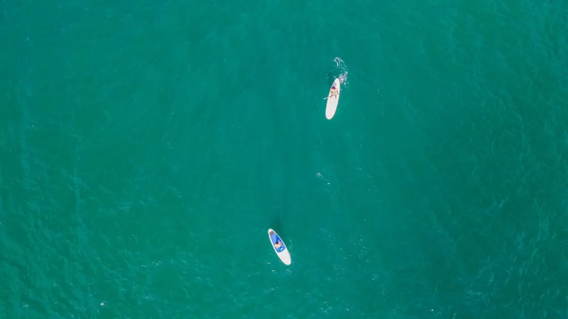 Two stand up paddle boarders enjoying the waters off of Mexico's Costa Careyes.