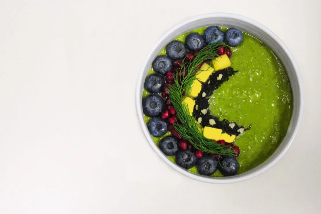 Spirulina powder smoothie bowl with colorful fruit topping how to use spirulina powder via Organic Authority