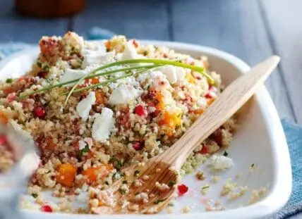 image of a persimmon recipe, winter salad with pomegranates, quinoa and feta