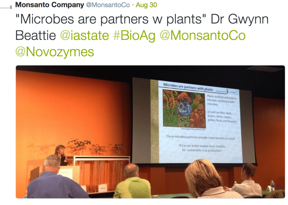Monsanto Company tweet quoting Dr Gwynn Beattie on microbes as plant partners, with a conference presentation photo