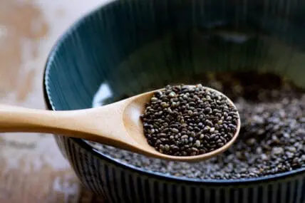 scooping chia seeds from a bowl