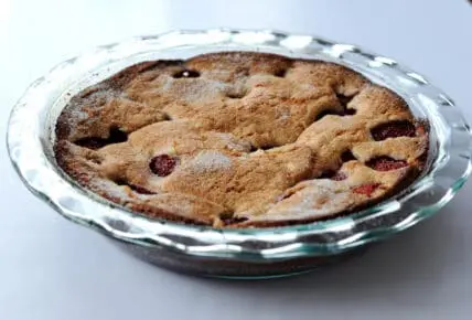 strawberry cobbler baked in a deep dish pie pan by Pyrex. This easy dessert is flexible and can be made with what you have on hand.