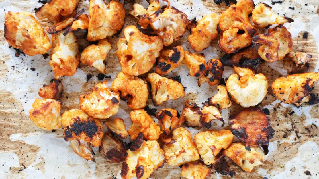 Healthy and delicious cauliflower hot wings on parchment paper.