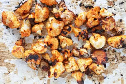 Healthy and delicious cauliflower hot wings on parchment paper.