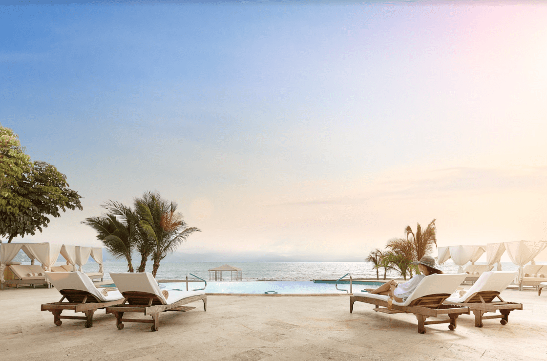 Beach club with a pool and a view of the ocean