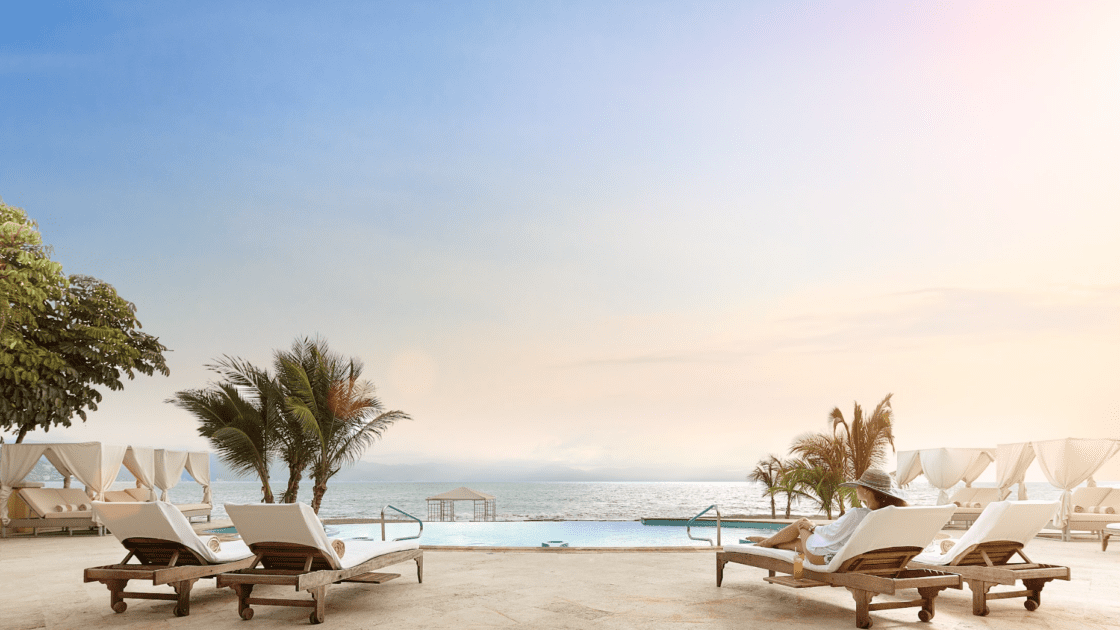 Beach club with a pool and a view of the ocean