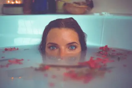 do women really need intimate washes? woman in bathtub