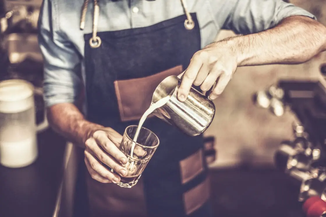 A barista making a latte