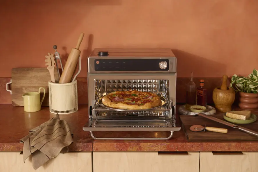 Image of the Our Place Wonder Oven Pro with the door open and a personal pizza inside.