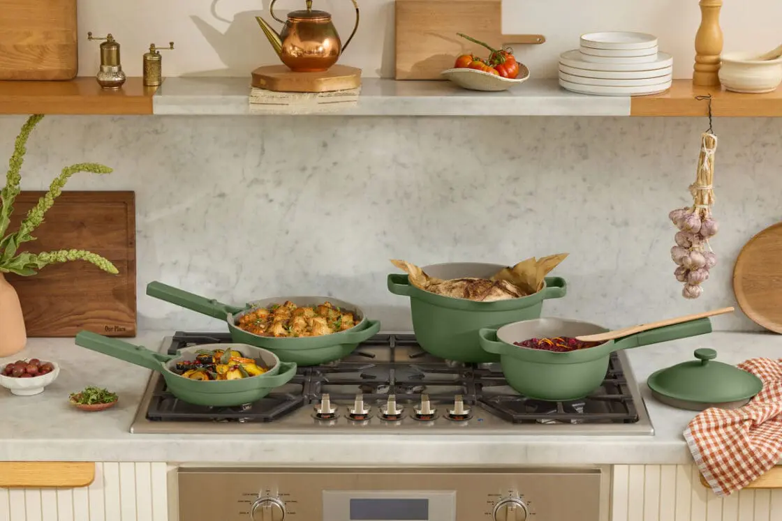 Image of the Our Place ceramic cookware set, including the Always Pan 2.0 and the Perfect Pot 2.0, set in a warm and cozy kitchen.