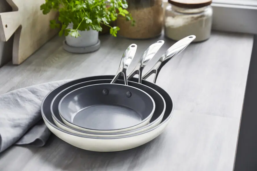 Image of three Valencia Pro frypans in the color cream nested inside of each other.