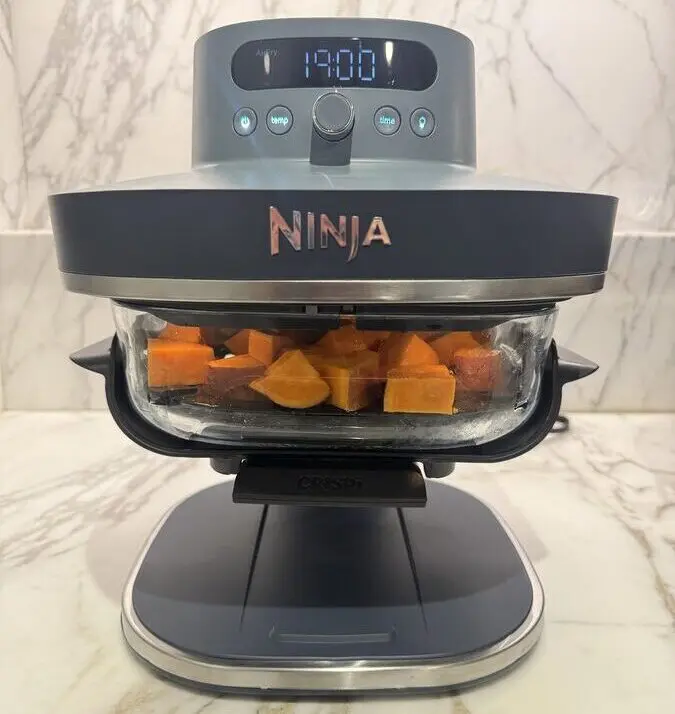 Image of the Ninja Crispi Pro being used to air fry sweet potatoes.