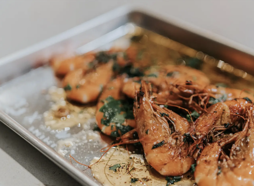 Image of a Made In aluminum sheet pan featuring some roasted garlic shrimp.