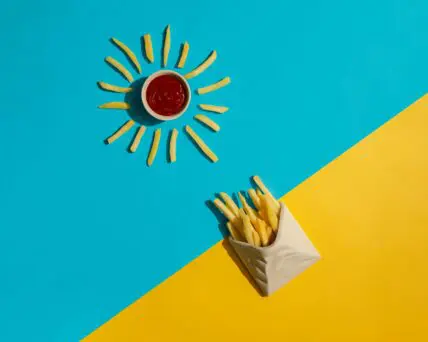 Image of french fries in the shape of sun rays surrounding ketchup. McDonalds Happy meals just got healthier aditya saxena unsplash