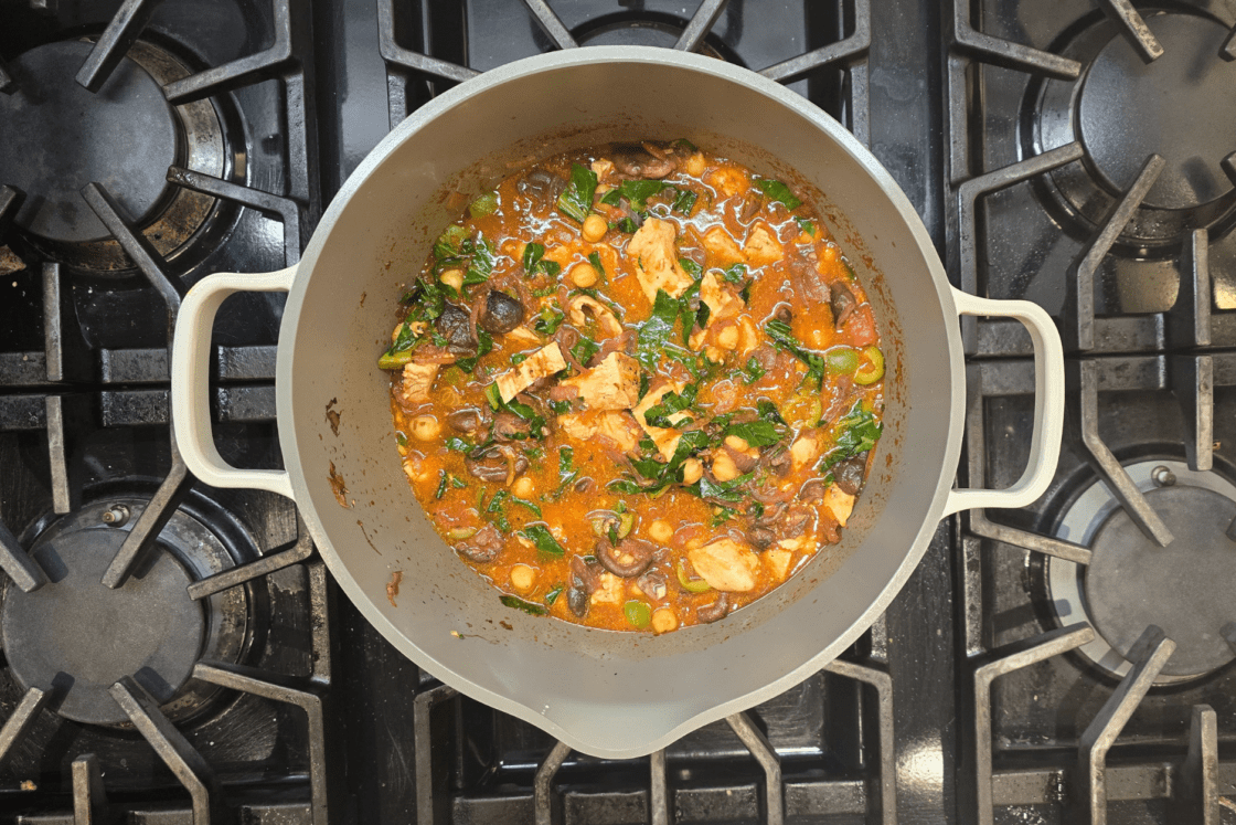 Image of a stew brewing in the Our Place Always Pot 2.0 on a stovetop.