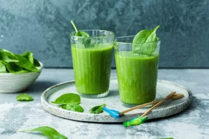 image of two glasses of green smoothies with spinach