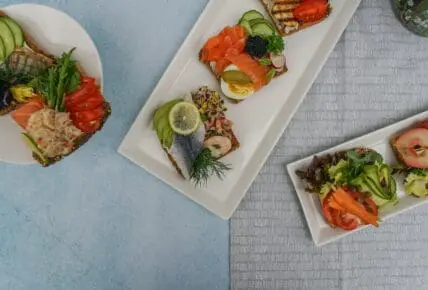image of plated healthy fat recipes with salmon, fish, and avocado