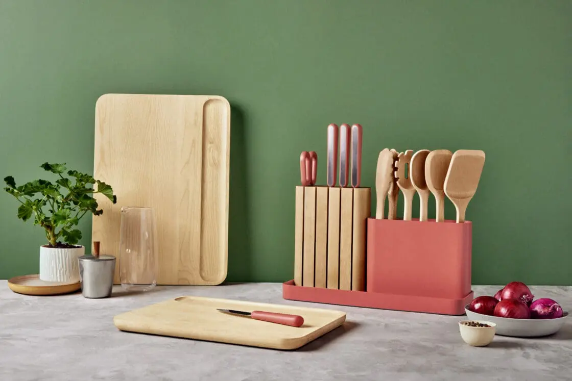 caraway prep set and cutting boards on countertop against green wall. 