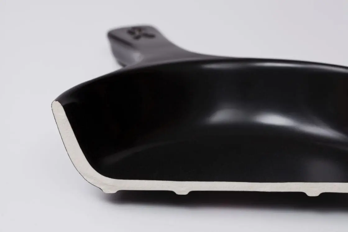 Image of the Xtrema Signature Skillet cut in half, with the cross-section showcasing the pure ceramic material.