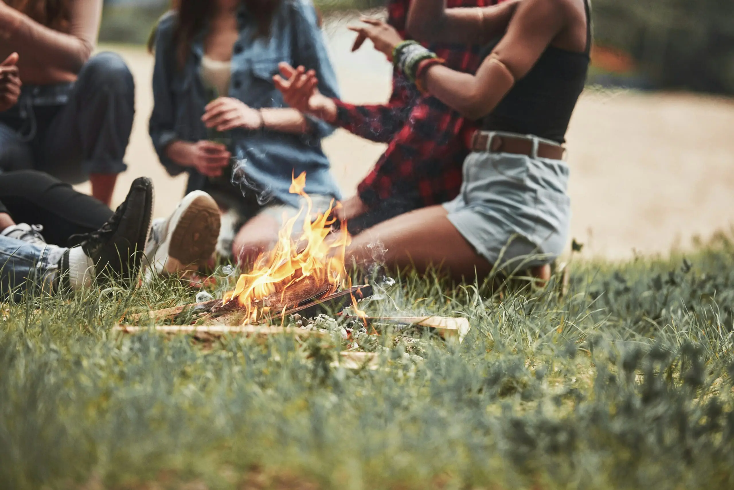 Image of friends sitting around a campfire telling stories of their adventure vacation travel