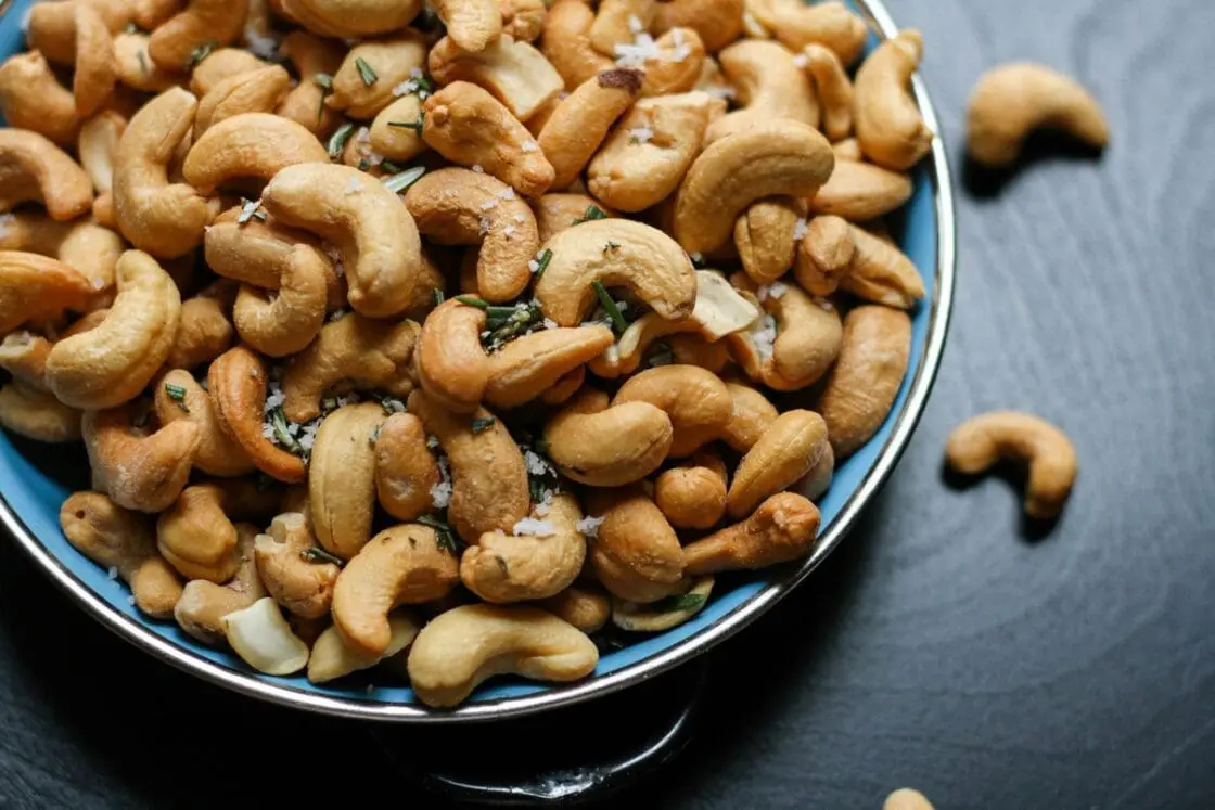 Image of an overflowing plate of roasted cashew nuts.