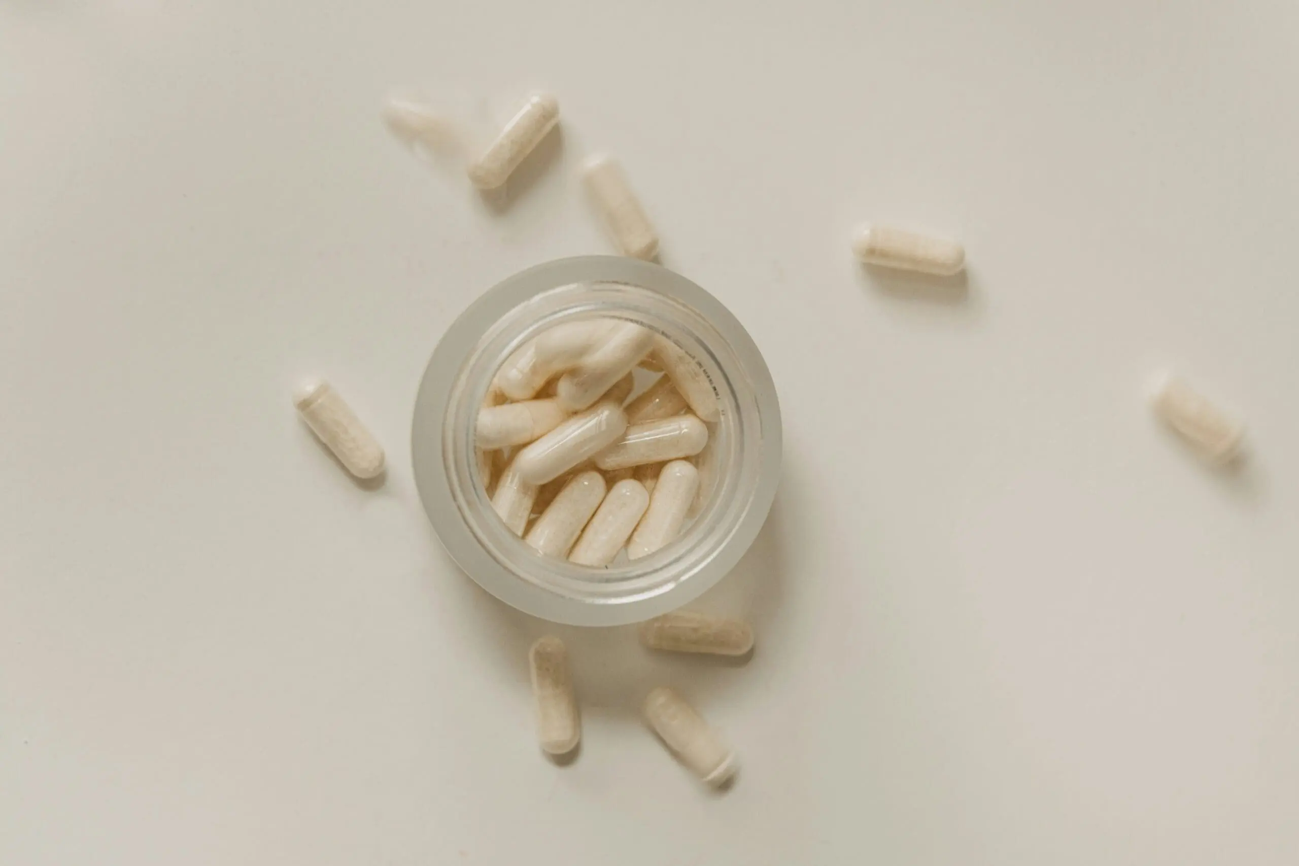 Image of an overhead view of a glass jar of supplements, natural heartburn relief