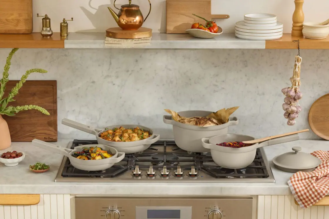 Image of the Our Place Always Pan and Perfect Pot set in Steam, with each pan and pot filled with food on a neat stovetop in a modern kitchen.