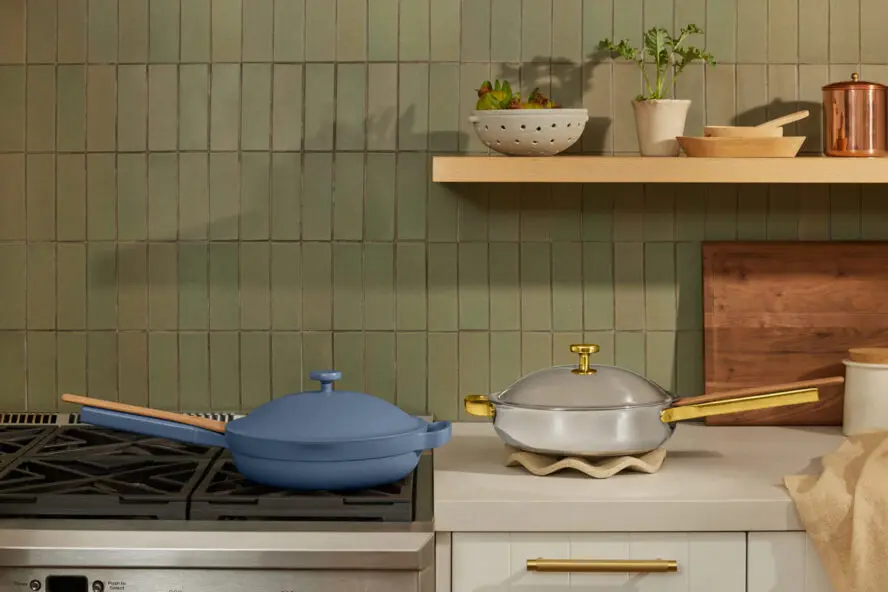 Image of two Our Place pans in a kitchen — the Always Pan in Blue Salt and the Titanium Always Pan Pro.