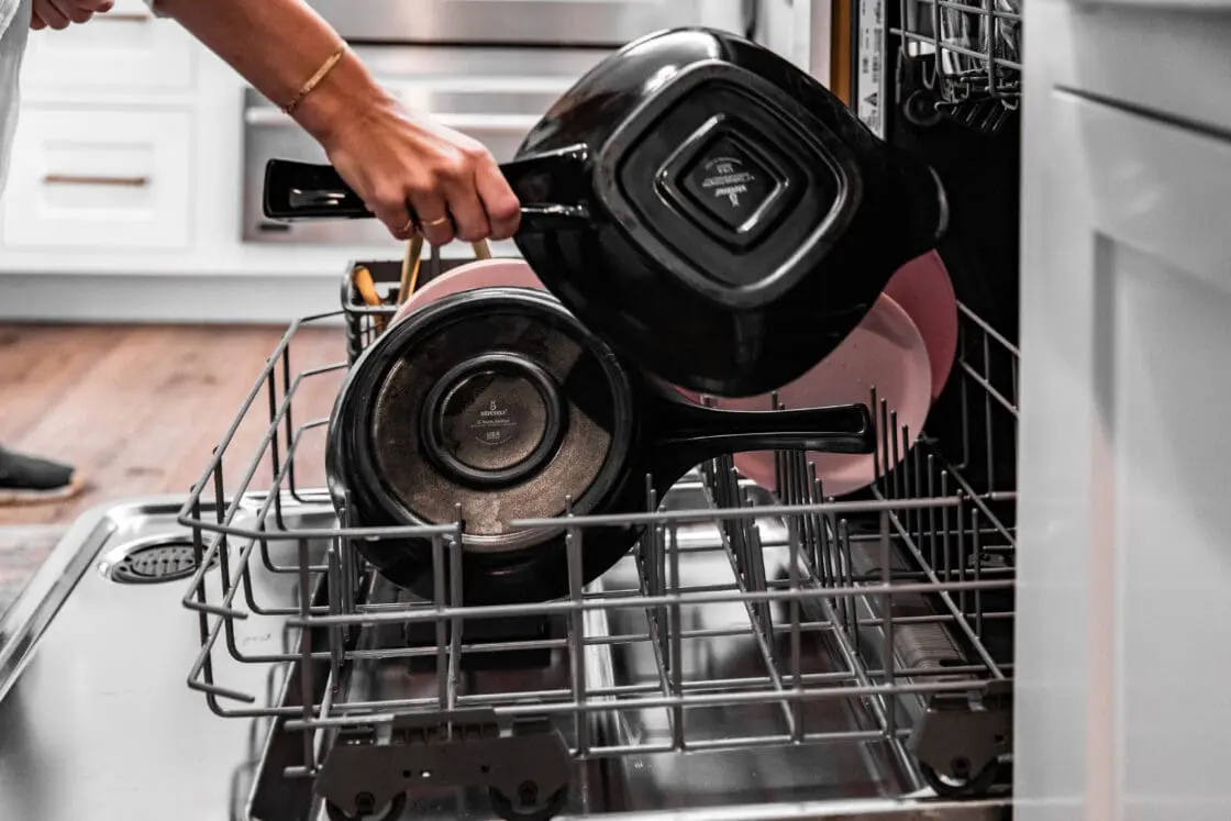 Image of safe cookware being placed into a dishwasher. Xtrema cookware is pure ceramic, one of the safest cookware materials out there.