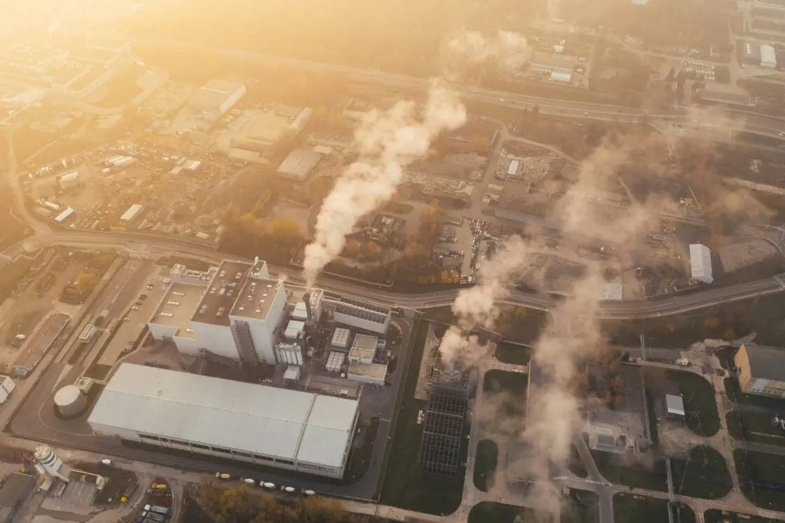 Image of an aerial view of a factory with smoke billowing out of several smoke stacks. Will EPA climate change stance be reversed?