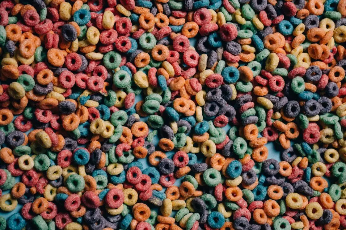 Image of hundreds of pieces of artificially colored Froot Loops cereal.