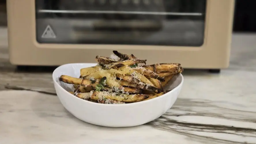 Image of our place air fryer made french fries in front of the Our Place Wonder Oven