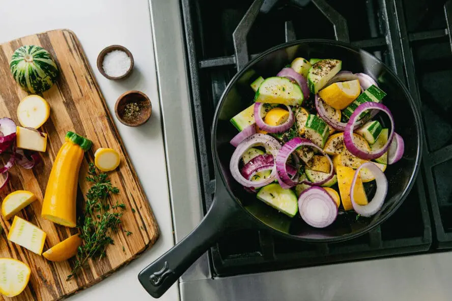Image of an Xtrema pure ceramic black skillet on a stovetop — ceramic cookware pros and cons include its ability to heat evenly with no hot spots.