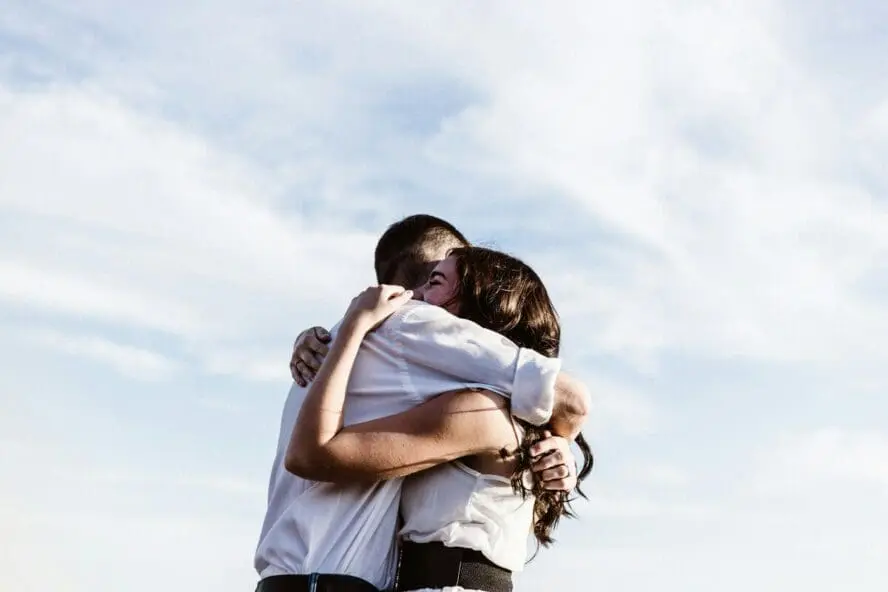 Image of a woman and a man hugging, which is a great way to approach how to prevent a burnout.