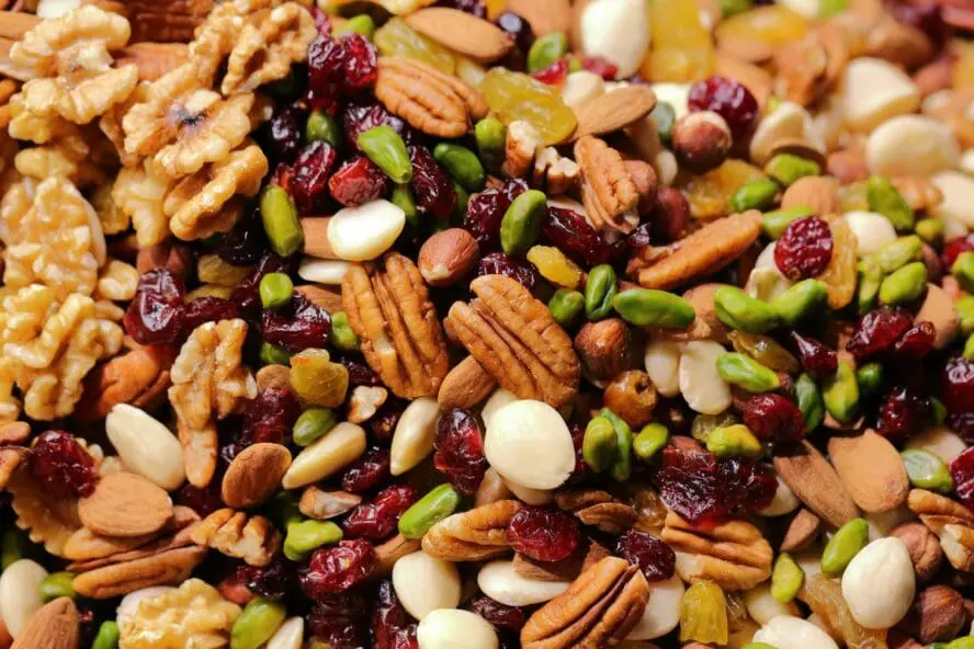 Close-up image of a pile of various nuts, including almonds, pistachios, and walnuts, which are all good foods for brain health.