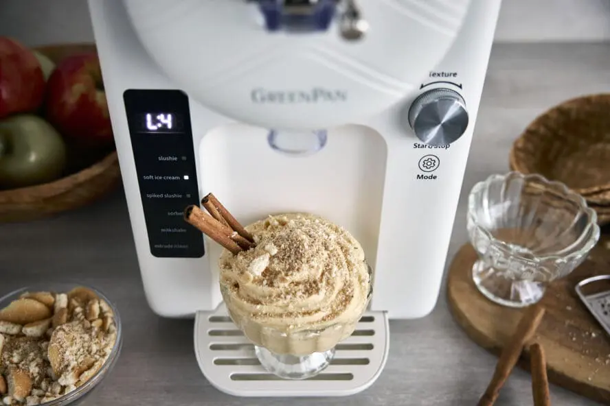Image of the GreenPan Frost in Cream with a cup of pumpkin cream topped with walnuts and a cinnamon stick.